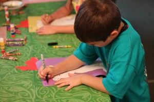 A child does arts and crafts at one of the churches this summer for Vacation Bible School.