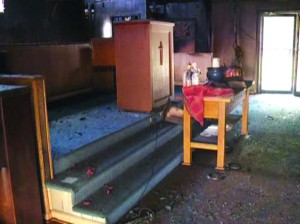 A photograph shows damage to the sanctuary of Bayou Baptist Church in Slidell from a fire on Oct. 22.
