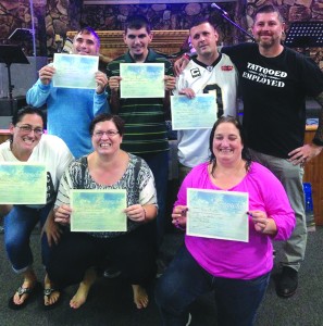 Members of Revival Life Church proudly show their certificates of baptism. Pastor Dexter Gaspard makes sure candidates of baptisms understand what it means - a public expression of how they are giving up their old life for a new one in Jesus Christ. Submitted photo
