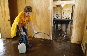 Southern Baptist Disaster Relief volunteer Linda Woods of Benton, Ky., a member of Hamlet Baptist Church, sprays a flood damaged home with antibacterial spray in Farmerville near Lake D'Arbonne. Disaster Relief volunteers assisted flood survivors in Farmerville. NAMB photo by Stewart F. House