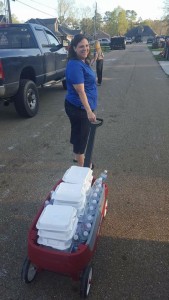 A volunteer from New Hope Baptist Church in Independence delivers a box of spaghetti dinners on Sunday, March 13, 2016.