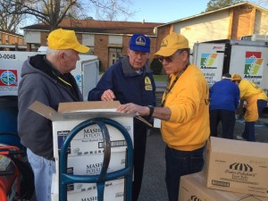 Arkansas Baptist Disaster Relief blue hat Harold Johnson (center) looks through a box of food with fellow team members at Horseshoe Drive Baptist Church in Alexandria on March 22, 2016. They will serve 850 meals per day.