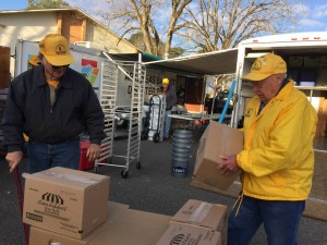Arkansas Baptist Disaster Relief team members carry boxes of food to a station, where they are prepared as part of a meal that is distributed to food victims.