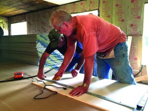 Members of Simpson Baptist Church work inside a home in Evans that was damaged in March by several feet of flooding. They were joined by members of an Illinois Baptist Disaster Relief team.