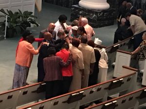 A group of people pray for Oren Conner, pastor of First Baptist Church in Baton Rouge. The church hosted a solemn prayer assembly on July 24, 2016. Dana Truitt photo