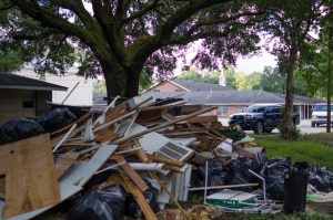 Piles of debris from the flood-damaged parsonage at Faith Baptist Church in Baker await removal. Marilyn Stewart photo