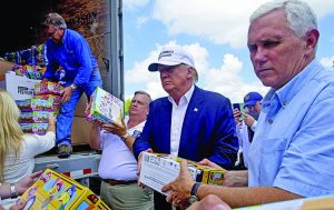 Republican presidential candidate Donald Trump and his running mate, Indiana Gov. Mike Pence, right, help to unload supplies for flood victims during a tour of the flood damaged area Denham Springs. Photo courtesy of Greenwell Springs Baptist Church
