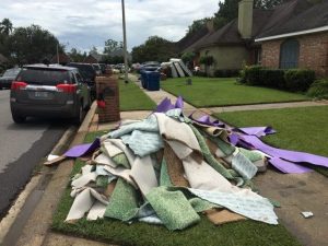 Debris is piled in the yard of a Lafayette home. Dustin Lee photo