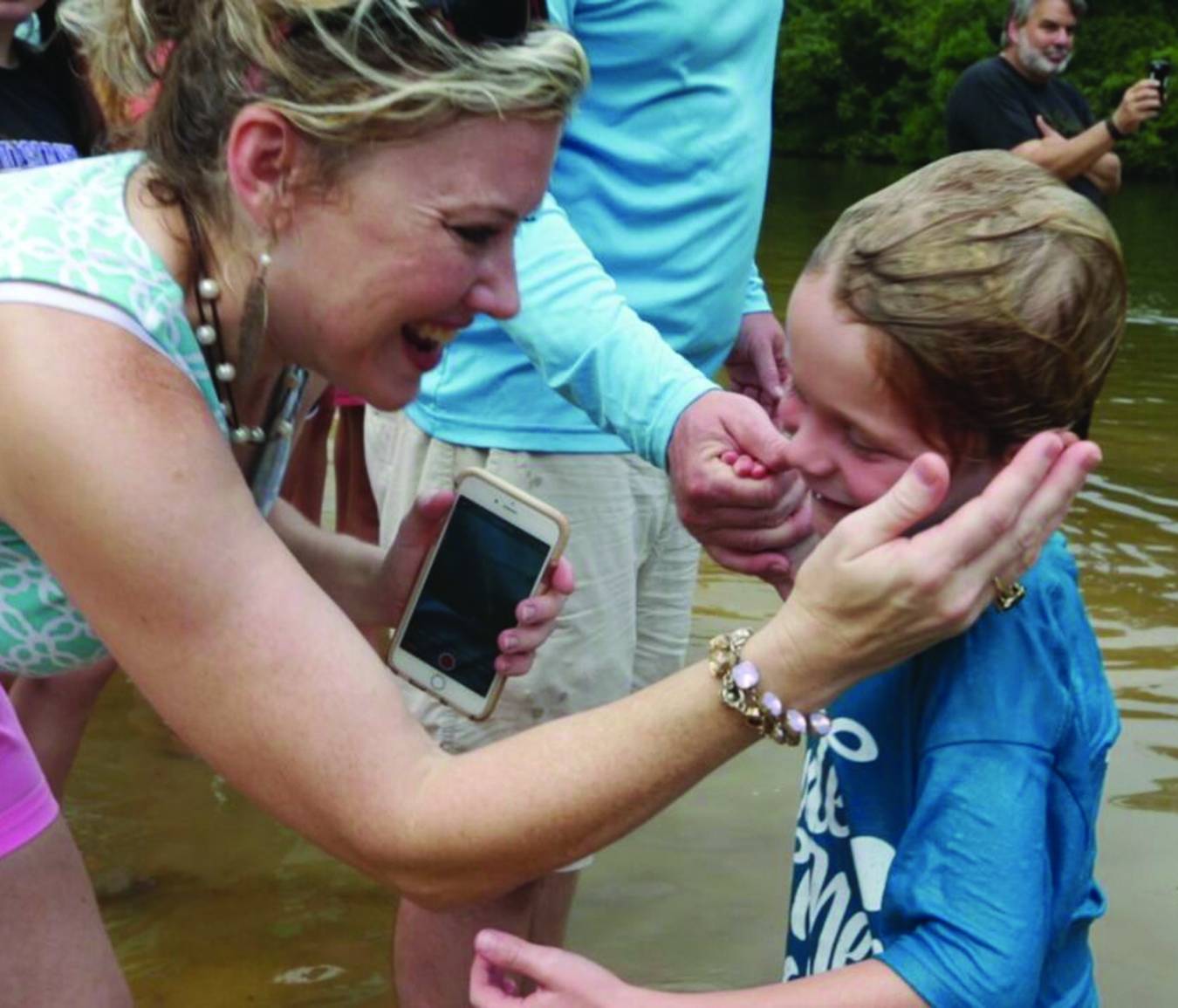 Renee Strickland (left) smiles as she congratulates her son, Harris, on being baptized Sept. 4. He was one of 77 baptized during a special service in the Bogue Falaya River in Covington.