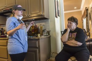 Sarah Farley, associate director of Louisiana State University's Baptist Collegiate Ministry, discusses mold removal with homeowner Paulette LaCombe, Sept. 3, 2016, at a flood-damaged home in Denham Springs, La. Farley helped organize a massive mud out event, bringing more than 450 student members of LSU Baptist Collegiate Ministry and other collegiate church ministries from six states, to help survivors of the mid-August flood.  (Photo by Carmen K. Sisson)