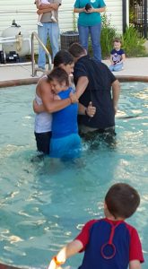 Ami Small and a camper from Boys Camp share a hug after they are each baptized following Boys Camp at Clara Springs Baptist Encampment. 