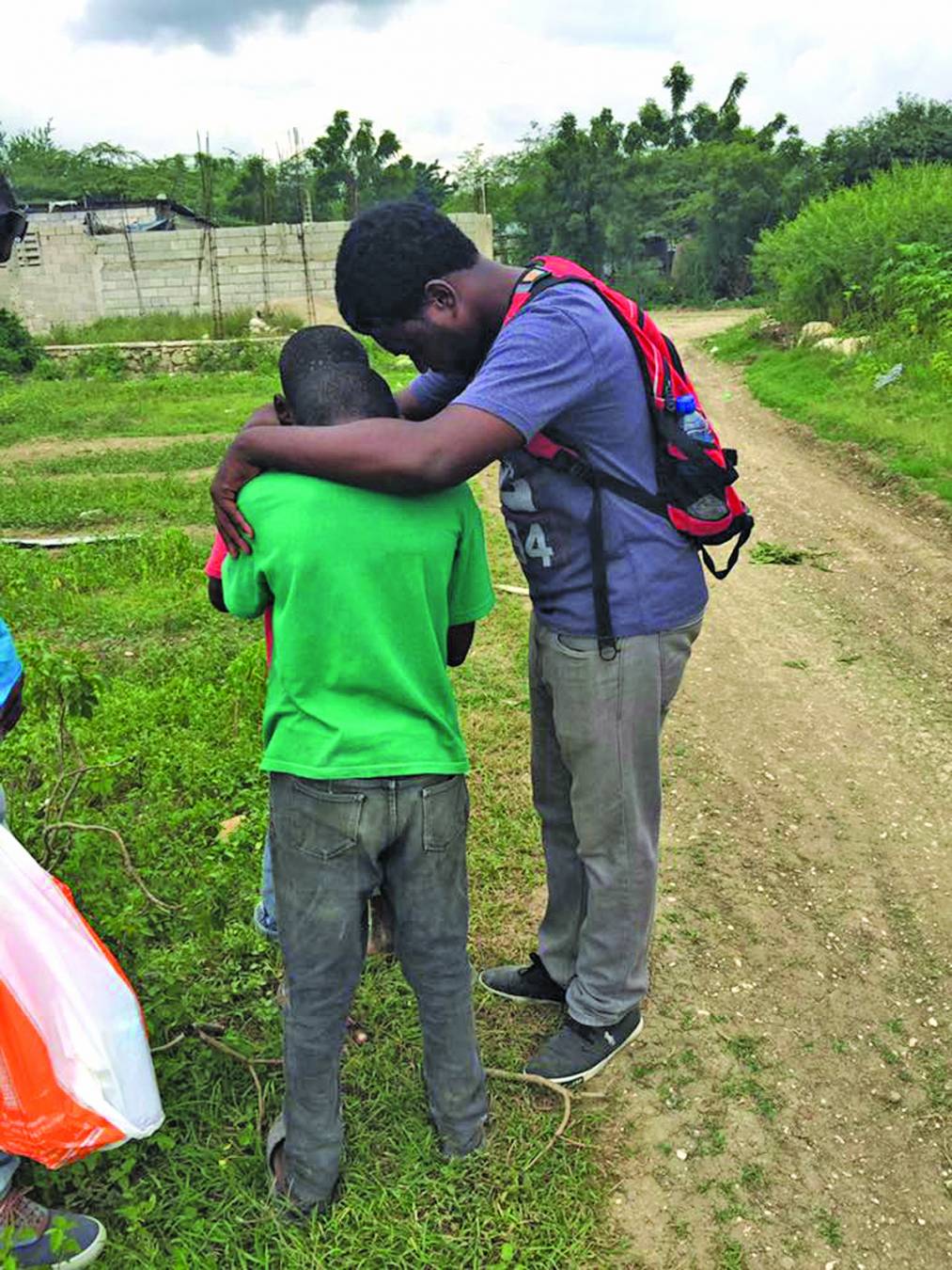 A Haitian boy is prayed for during a Louisiana Baptist mission trip to the country. Mission teams will be needed to build a children’s village, medical clinic, pastor’s training center and hotel in Haiti.