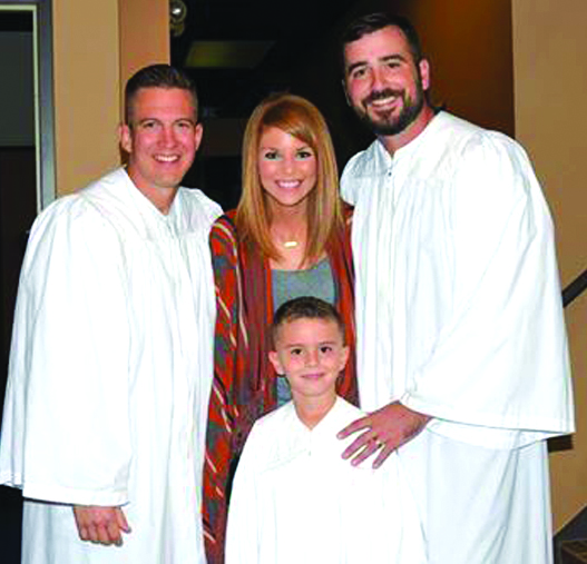 Pastor John Lary (left) stands with six-year-old Hayden Heaberlin and his parents, April and Dusty, the day of his baptism. He is one of 28 people baptized in 2016 at Calvary Baptist Church in Shreveport.