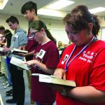 Students look up a Scripture passage during the 2018 Louisiana Baptist State Bible Drill competition April 28 at First Baptist Church in Pineville. The participants in the Bible drills and Speakers’ Tournaments go through a three-step process which begins in the church before moving on to the district level and then finally advancing to the state level.