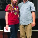 Hannah James stands on stage beside Louisiana Baptists Youth Ministry Strategist Steve Maltempi. James, who is a member of Fellowship Church in Greenwell Springs, was chosen to represent Louisiana Baptist at the National Youth Bible Drill Tournament.