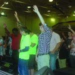 Evangelist Rick Gage asks for a raise of hands from those making a decision during a time of invitation at the Tomorrow's Hope Crusade.