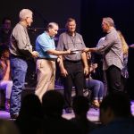 Evangelist Rick Gage presents members of the Tomorrow's Hope GO TELL Crusade with plaques of appreciation. Doug Collier photo