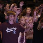 Students lift their hands in praise during a time of worship at the Tomorrow's Hope GO TELL Crusade. Doug Collier photo