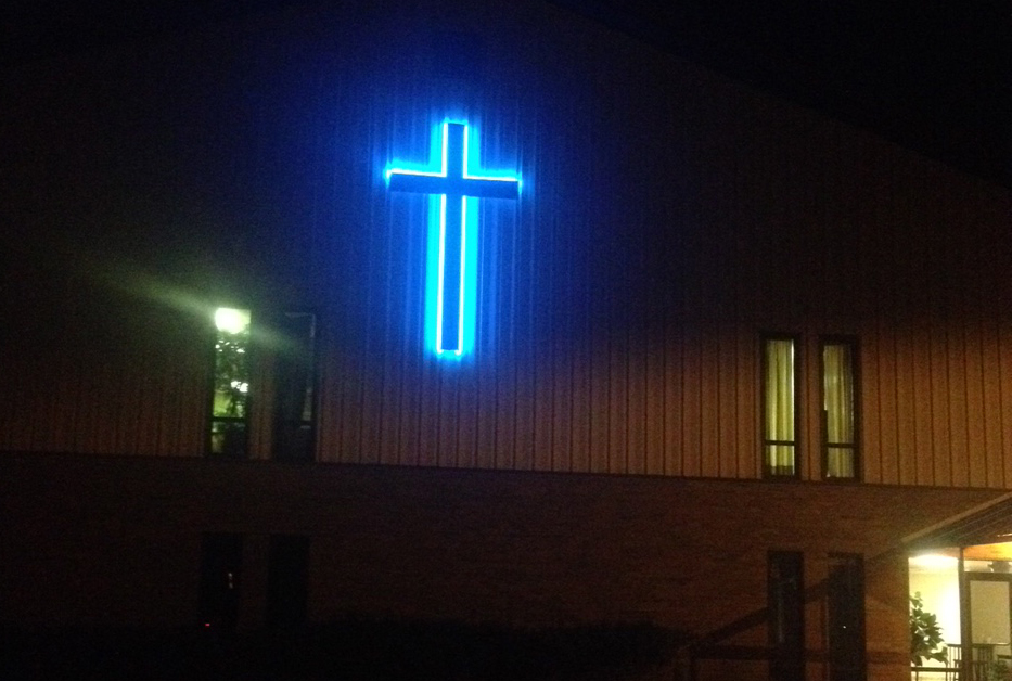 Eastwood Baptist Church places blue cross on worship