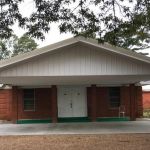 The first facility was a wooden building located not far from the present building. This 2-story structure was used until it burned in later years. The second building was erected across the road from where the present structure is located. It was a small box house with 12-inch vertical planks. In 1900, the congregation under the leadership of Pastor Joseph Rudicille, appointed a committee of three men to buy land for a cemetery. In 1969, the current brick structure was built beside the cemetery.