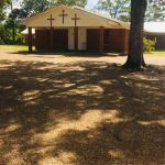 The first facility was a wooden building located not far from the present building. This 2-story structure was used until it burned in later years. The second building was erected across the road from where the present structure is located. It was a small box house with 12-inch vertical planks. In 1900, the congregation under the leadership of Pastor Joseph Rudicille, appointed a committee of three men to buy land for a cemetery. In 1969, the current brick structure was built beside the cemetery.