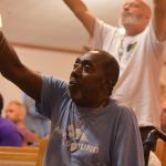 An inmate at the Louisiana State Penitentiary at Angola lifted his hands toward heaven during a time of worship at a revival on the prison grounds September 19.